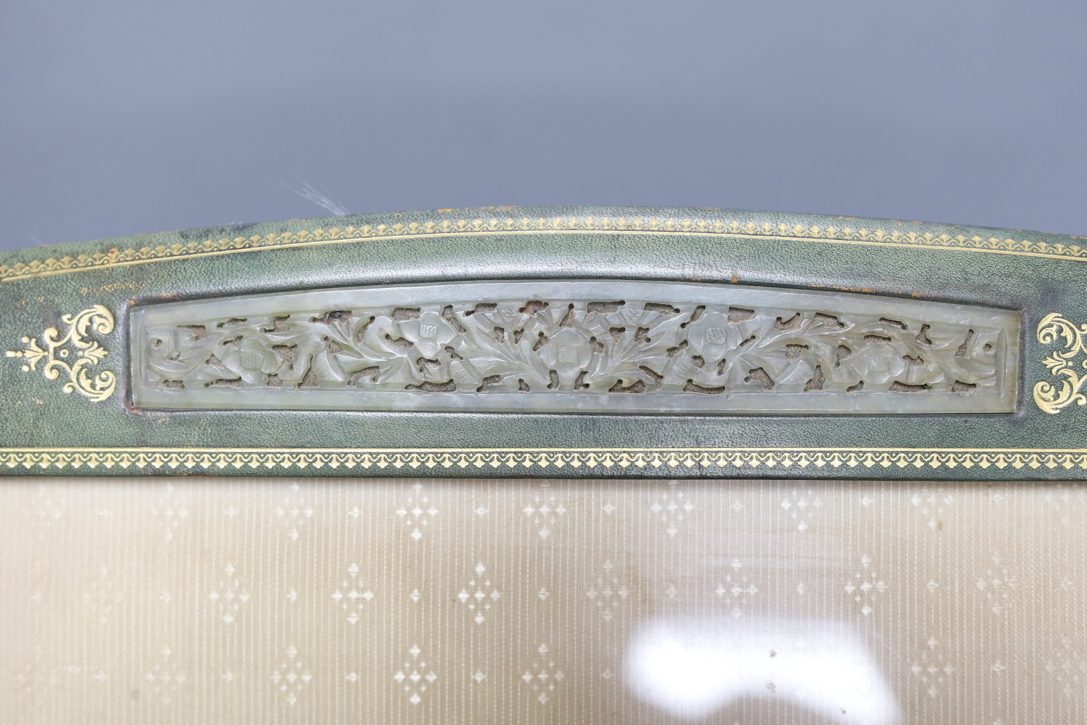 An early 20th century tooled photograph frame with inset Chinese pierced bowenite jade panel, 43cm tall